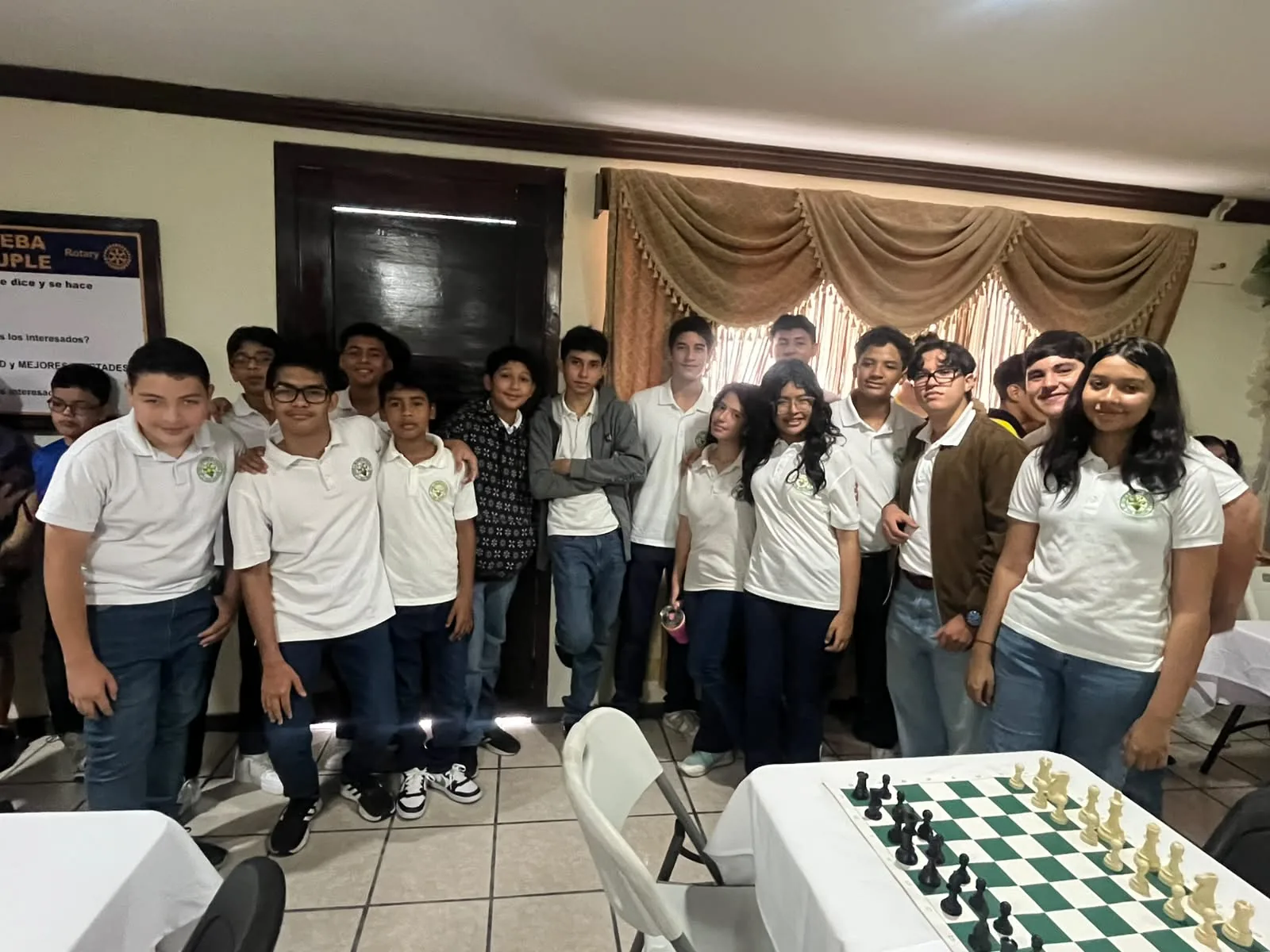 Brassavola chess delegation gathered around a chessboard