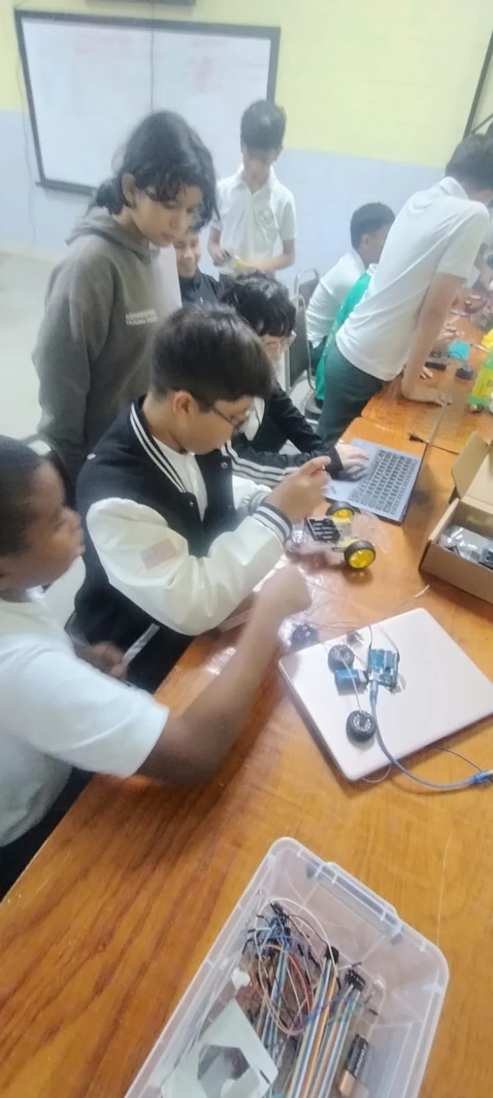 Students assembling a robotics project in class