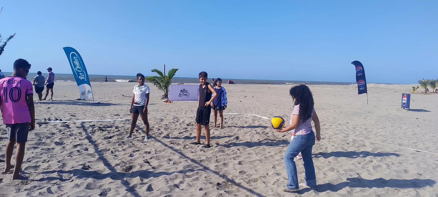 Students organizing a recreational beach volleyball game